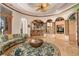 Unique living room with custom rug, rounded walls, ornately decorated beams and columns and built-in cabinets at 9291 Point Cypress Dr, Orlando, FL 32836