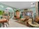 Bright living room with tile floors, large windows, decorative columns, and archways at 9291 Point Cypress Dr, Orlando, FL 32836