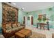 Living room featuring tile floors, rattan furniture, textured walls, and unique decorations at 9291 Point Cypress Dr, Orlando, FL 32836