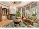 Cozy living room featuring unique fireplace, rounded windows, and a comfortable seating area at 9291 Point Cypress Dr, Orlando, FL 32836