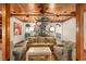 Cozy living room with a spiral staircase, coffered ceilings, and traditional furniture at 9291 Point Cypress Dr, Orlando, FL 32836