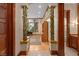 Hallway leading into an office with ample desk space, built-in shelving, and large windows at 9291 Point Cypress Dr, Orlando, FL 32836