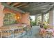 Charming outdoor kitchen and dining area with bar seating and lush landscaping, perfect for entertaining guests at 9291 Point Cypress Dr, Orlando, FL 32836