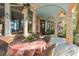 Elegant covered patio featuring an outdoor dining area with stunning views of the surrounding landscape at 9291 Point Cypress Dr, Orlando, FL 32836