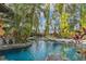 Picturesque pool featuring lush landscaping and tranquil fountains at 9291 Point Cypress Dr, Orlando, FL 32836