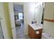 View from a bathroom to a bedroom featuring a wood vanity and gray rug at 974 Leeward Pl # 205, Altamonte Springs, FL 32714