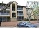 Exterior view of condo building with screened balconies and neatly manicured landscaping at 974 Leeward Pl # 205, Altamonte Springs, FL 32714