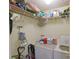 Functional laundry area with open shelving, washer, and dryer for simplified laundry days at 974 Leeward Pl # 205, Altamonte Springs, FL 32714