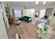 A well-lit living area showcasing a green velvet couch, kitchen, and dining table at 974 Leeward Pl # 205, Altamonte Springs, FL 32714