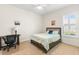 Bedroom with carpet, desk, and window with plantation shutters at 10144 Lake Miona Way, Oxford, FL 34484