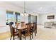 Well-lit dining room features a wood table with chairs and natural light from the window at 10144 Lake Miona Way, Oxford, FL 34484