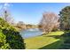 Picturesque lake view featuring manicured landscaping and inviting single Gathering homes at 10144 Lake Miona Way, Oxford, FL 34484