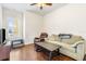 Cozy living room features wood floors, a comfortable sofa, and natural light at 10144 Lake Miona Way, Oxford, FL 34484