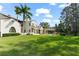 Expansive backyard showcasing the pool, covered patio, and lush landscaping of this luxury residence at 11324 Bridge House Rd, Windermere, FL 34786