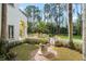 Landscaped backyard featuring a pool with a rock waterfall, lush greenery, and a gated entrance at 11324 Bridge House Rd, Windermere, FL 34786