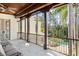 Expansive covered balcony with wooden beams overlooking backyard pool and greenery at 11324 Bridge House Rd, Windermere, FL 34786