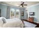 Bright bedroom with hardwood floors, arched windows, and stylish furnishings at 11324 Bridge House Rd, Windermere, FL 34786