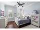 Comfortable bedroom featuring hardwood floors, white furniture, and bright, natural light at 11324 Bridge House Rd, Windermere, FL 34786