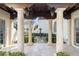 View of courtyard with travertine pavers and stone fountain at 11324 Bridge House Rd, Windermere, FL 34786