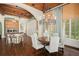 Open concept dining area with hardwood floors, stylish chandelier, and windows, adjacent to the kitchen at 11324 Bridge House Rd, Windermere, FL 34786