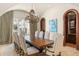 Formal dining room featuring a grand chandelier, long table, and arched entryways for elegant entertaining at 11324 Bridge House Rd, Windermere, FL 34786