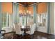 Dining room showcasing natural light from the many surrounding windows and a decorative chandelier at 11324 Bridge House Rd, Windermere, FL 34786