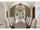 Formal dining room featuring a grand chandelier, long table, and arched entryways for elegant entertaining at 11324 Bridge House Rd, Windermere, FL 34786