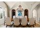 Formal dining room featuring a long table with seating, high ceilings, and decorative archways at 11324 Bridge House Rd, Windermere, FL 34786