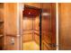 Residential elevator with wood paneling and carpet, offering convenient access to multiple floors at 11324 Bridge House Rd, Windermere, FL 34786