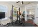 Spacious home gym with a weight rack and adjacent access to the upper level of the home at 11324 Bridge House Rd, Windermere, FL 34786