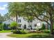 Beautiful exterior of a two-story home with lush front lawn and mature trees at 11324 Bridge House Rd, Windermere, FL 34786