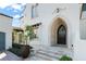 Elegant home featuring arched front door with a tile roof and green shrubbery at 11324 Bridge House Rd, Windermere, FL 34786