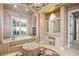 Luxurious bathroom features a soaking tub, vanity area and decorative sconces and chandelier at 11324 Bridge House Rd, Windermere, FL 34786