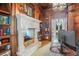 Office featuring a decorative fireplace with built-in bookshelves and arched doorway at 11324 Bridge House Rd, Windermere, FL 34786