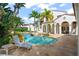 Inviting backyard pool and spa with lush landscaping and travertine patio at 11324 Bridge House Rd, Windermere, FL 34786