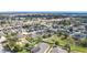 An aerial shot showcases a neighborhood with varied home designs, lush landscaping, and a sense of community at 123 Vitoria Rd, Davenport, FL 33837