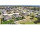 An aerial view of a residential neighborhood featuring well-maintained homes with fenced yards and mature trees at 123 Vitoria Rd, Davenport, FL 33837