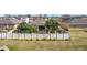 Aerial view of fenced backyard, mature trees, and a screened patio at 123 Vitoria Rd, Davenport, FL 33837