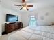 Cozy bedroom featuring a ceiling fan, dresser, and natural light from a window at 123 Vitoria Rd, Davenport, FL 33837