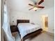 Spacious bedroom with a king bed, decorative wall, and modern ceiling fan at 123 Vitoria Rd, Davenport, FL 33837