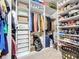 Organized walk-in closet featuring custom shelving, hanging rods, and ample storage space for clothes and accessories at 123 Vitoria Rd, Davenport, FL 33837