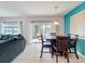 Bright dining area with a wooden table, sliding glass door, and neutral paint at 123 Vitoria Rd, Davenport, FL 33837