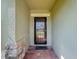 Inviting front entrance with a black security door, brick pavers, and a welcoming mat at 123 Vitoria Rd, Davenport, FL 33837