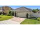 Inviting home features a well-maintained lawn, brick driveway, and manicured bushes at 123 Vitoria Rd, Davenport, FL 33837