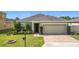 Charming single-story home with a well-manicured lawn and brick-paved driveway at 123 Vitoria Rd, Davenport, FL 33837
