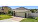 Charming single-story home with well-manicured lawn, brick driveway, and a two-car garage at 123 Vitoria Rd, Davenport, FL 33837