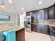 Kitchen with stainless steel appliances, granite counters, tile backsplash, and dark cabinets at 123 Vitoria Rd, Davenport, FL 33837