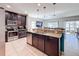 View of the kitchen with stainless appliances, granite counters, and an eat-in bar at 123 Vitoria Rd, Davenport, FL 33837