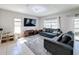 Living room with tile floors, two sofas, and a large window overlooking the backyard at 123 Vitoria Rd, Davenport, FL 33837