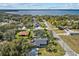 A beautiful aerial view of a home near a lake and among trees, showcasing the surrounding landscape and neighborhood at 12442 Sunshine Dr, Clermont, FL 34711